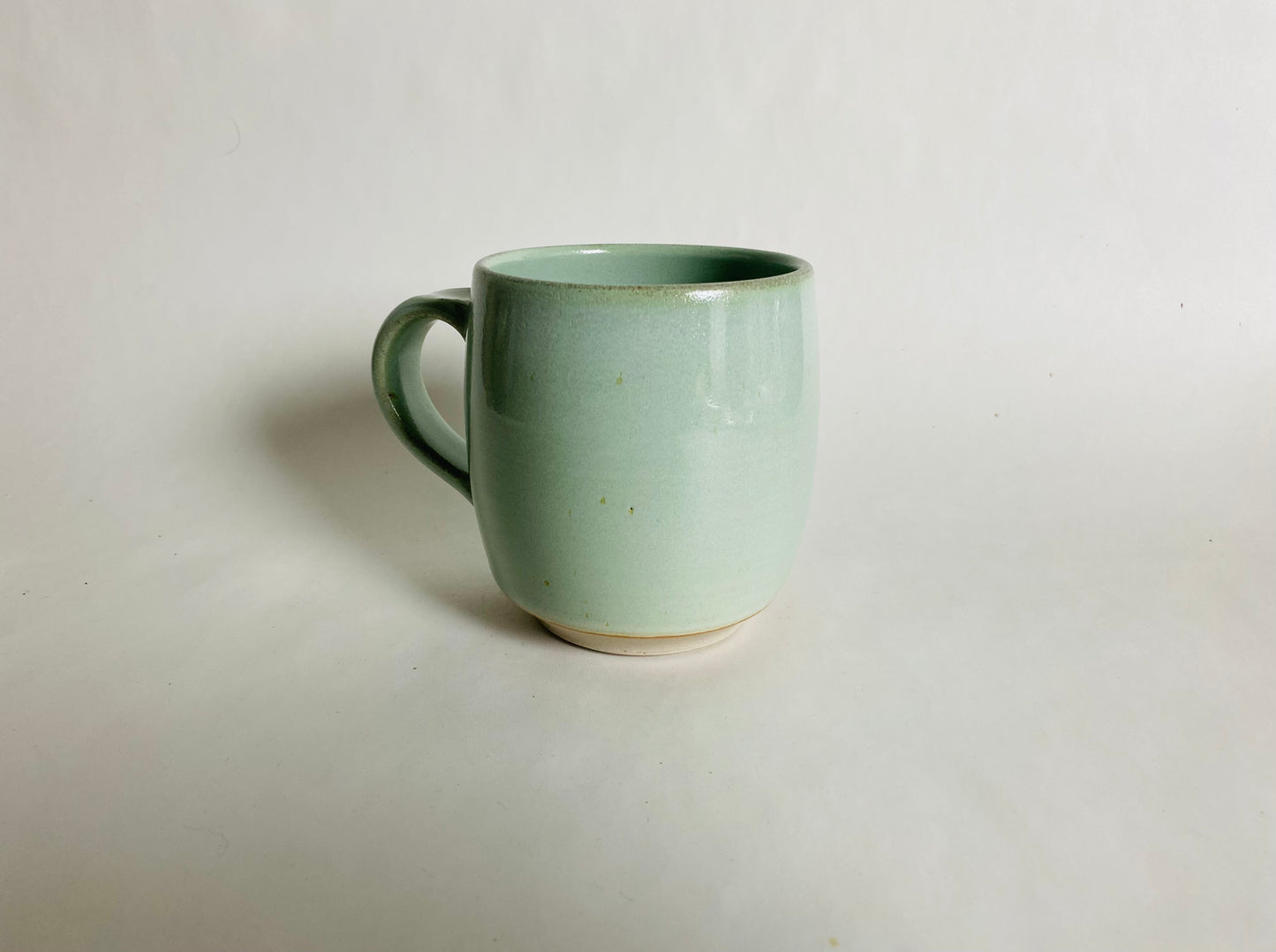 Medium Size Porcelaneous Mug with a Light Green Glaze
