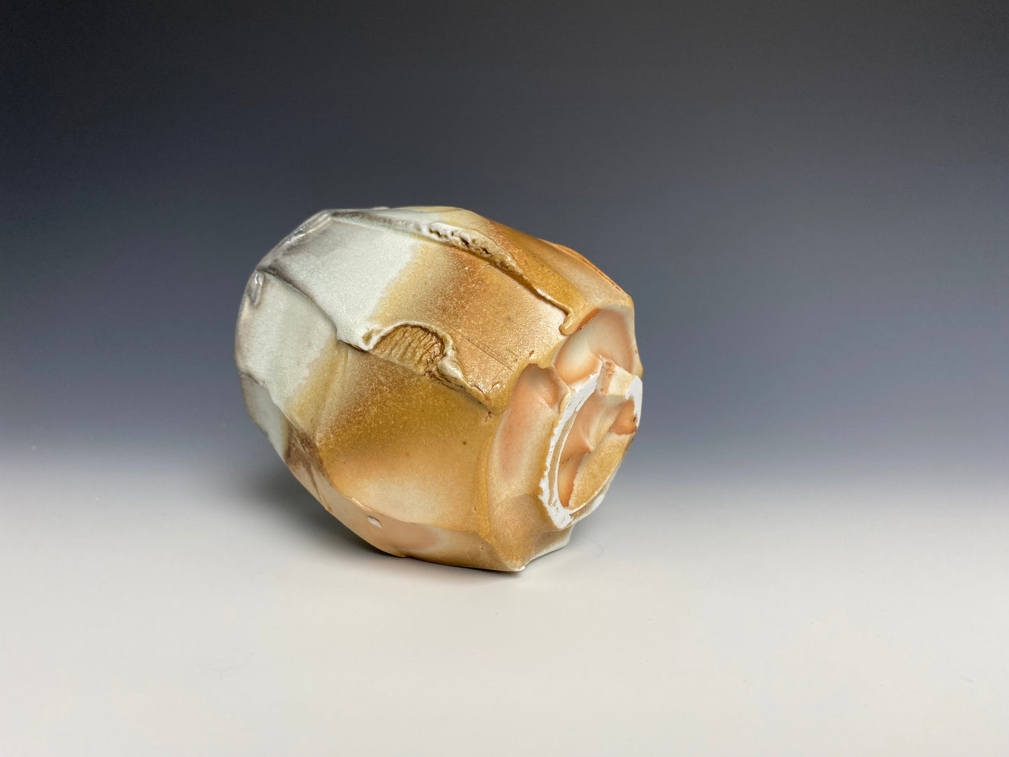 Wood fired faceted yunomi, porcelain clay.