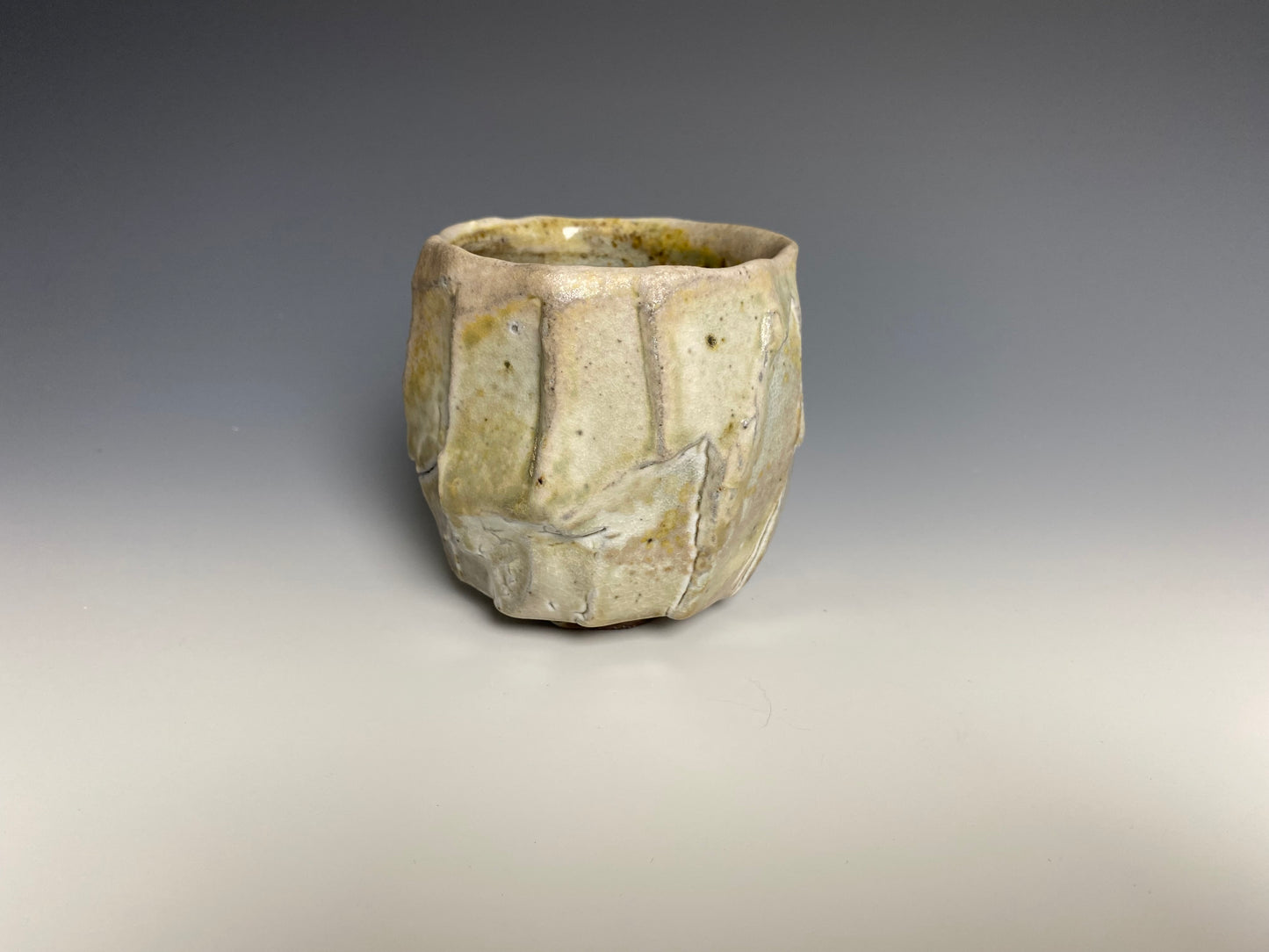 Wood fired porcelain faceted cup, Shino glaze.