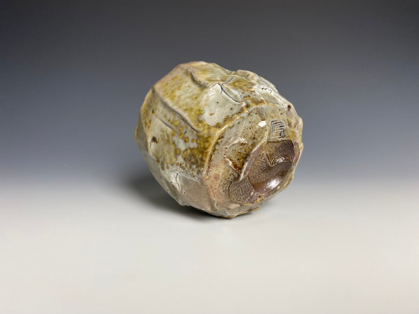 Wood fired porcelain faceted cup, Shino glaze.