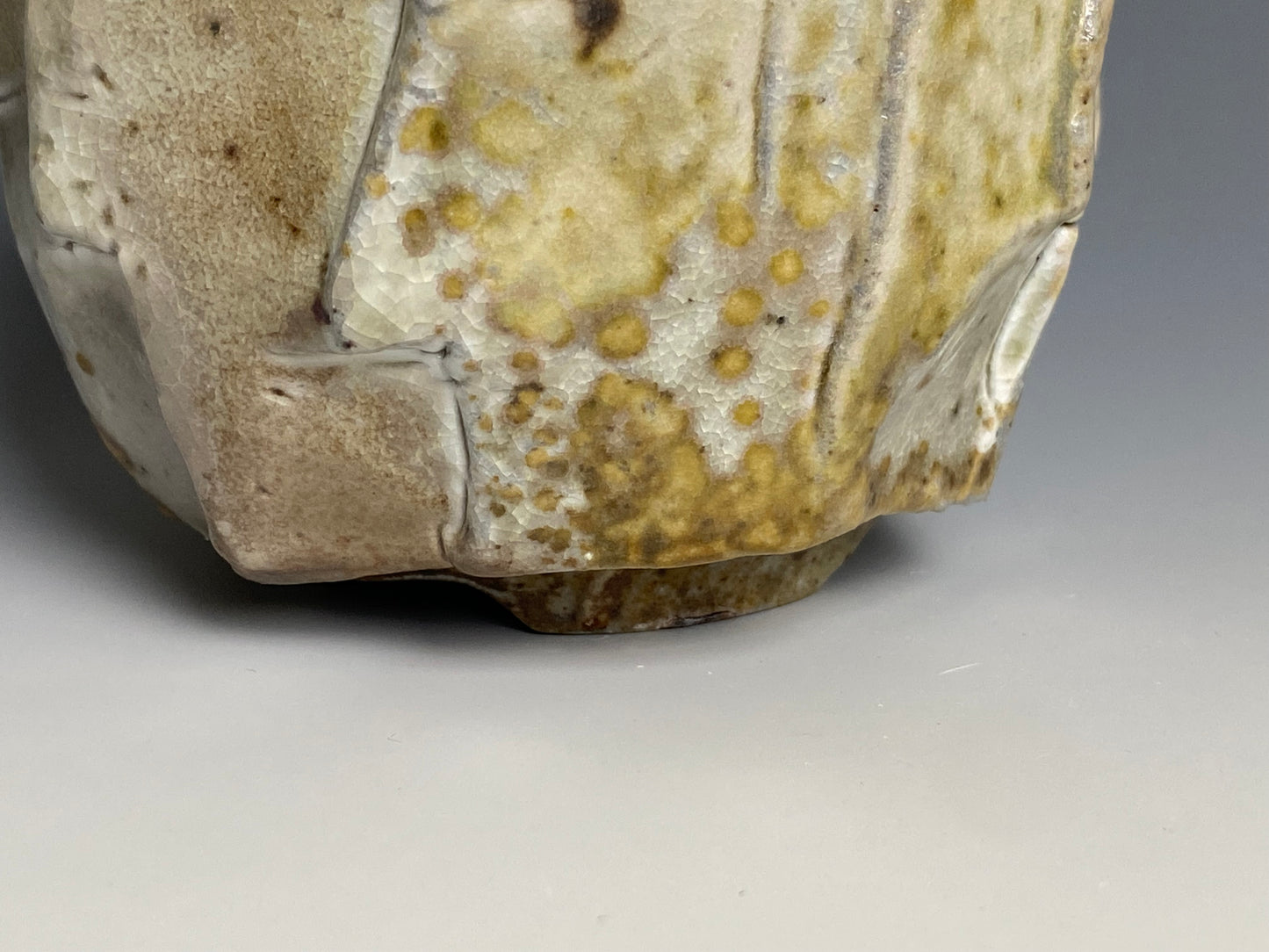 Wood fired porcelain faceted cup, Shino glaze.