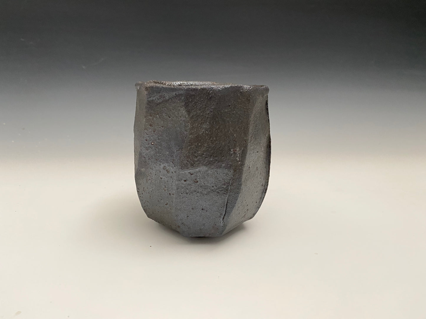 Faceted black clay cup