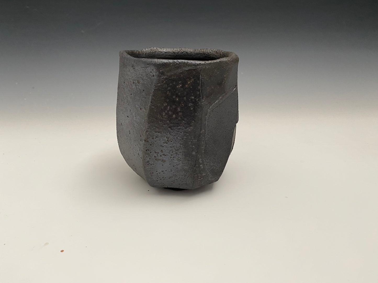Faceted black clay cup