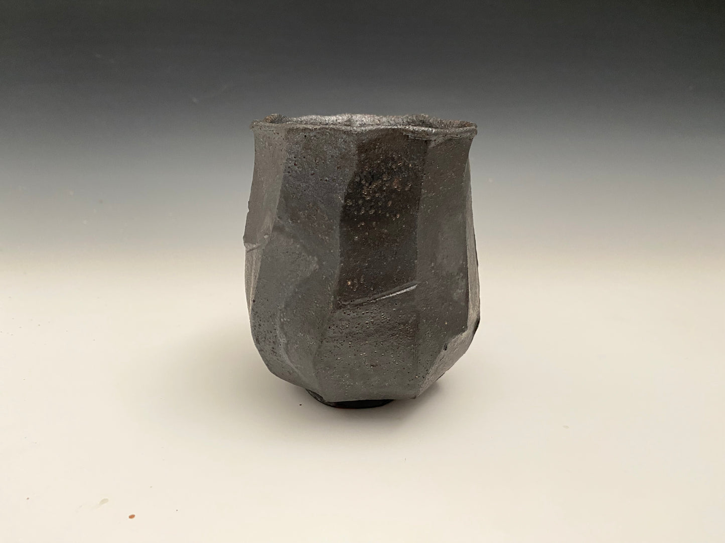 Faceted black clay cup