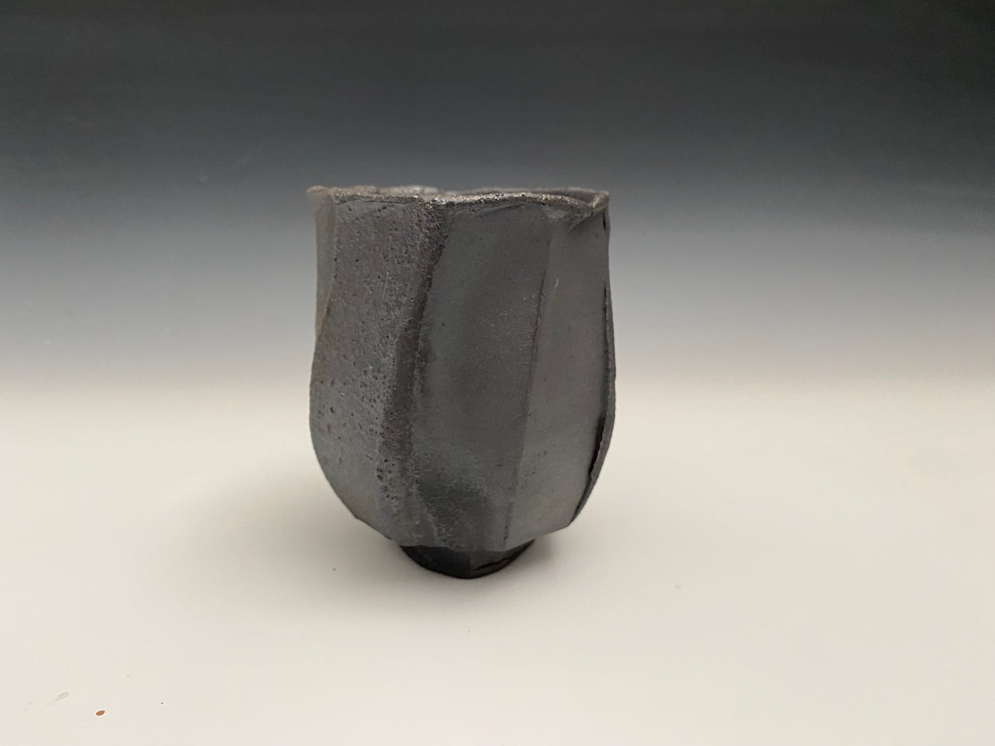 Faceted black clay cup
