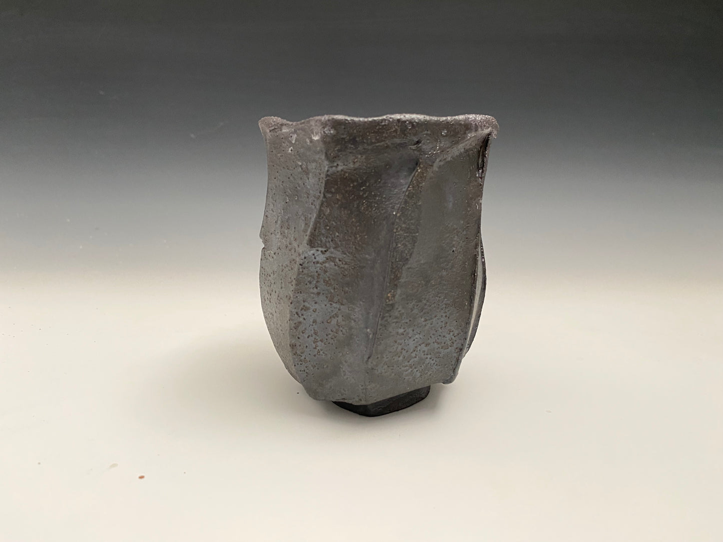 Faceted black clay cup