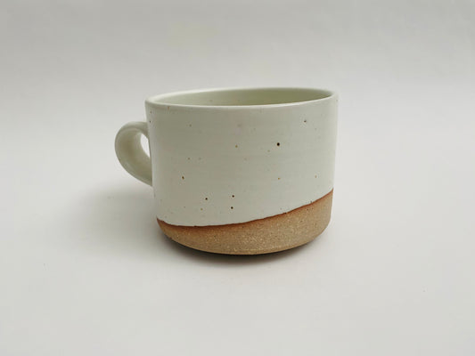 White glazed mug with bare clay accent