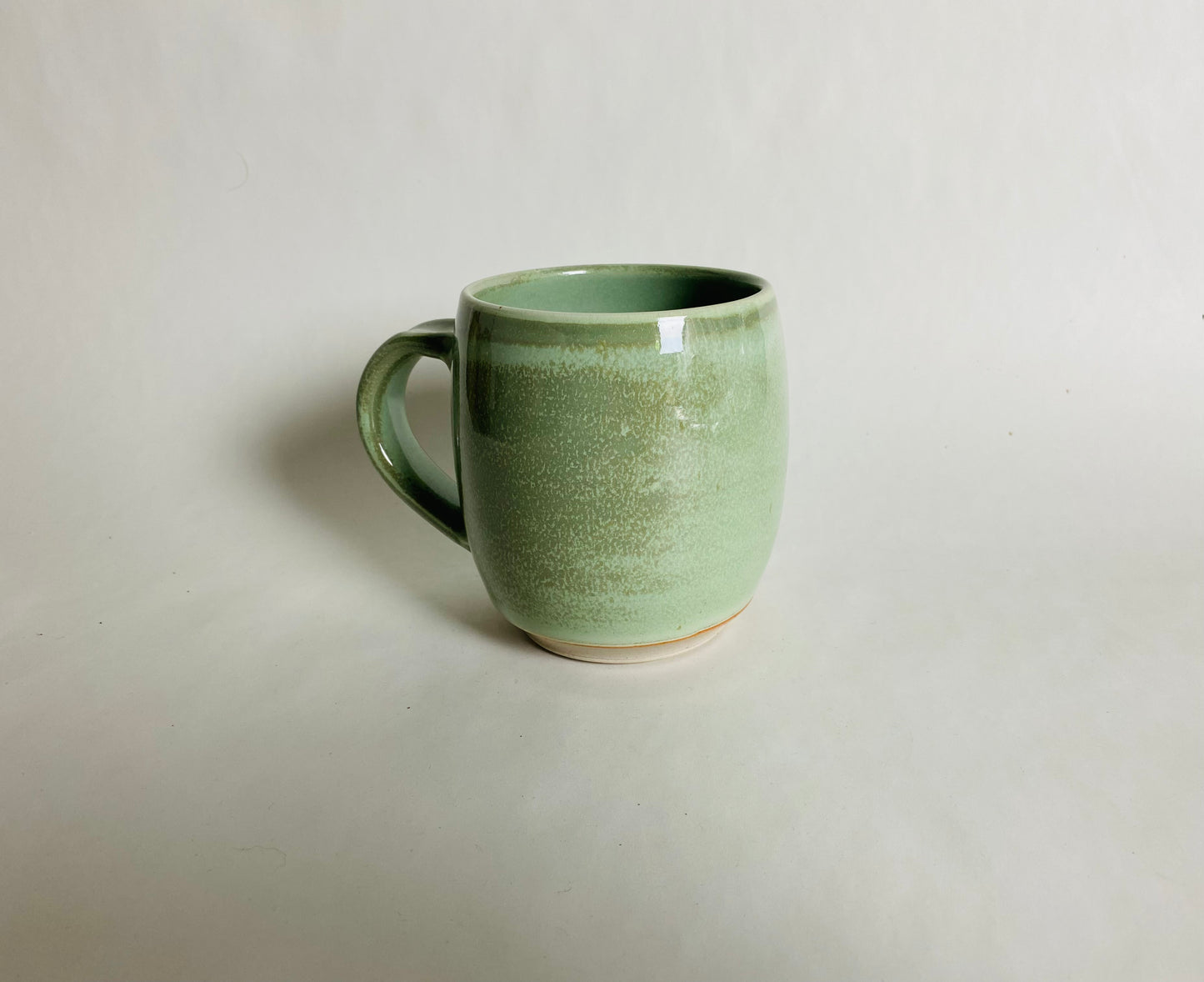Medium Size Porcelaneous Mug with a Light Green Glaze