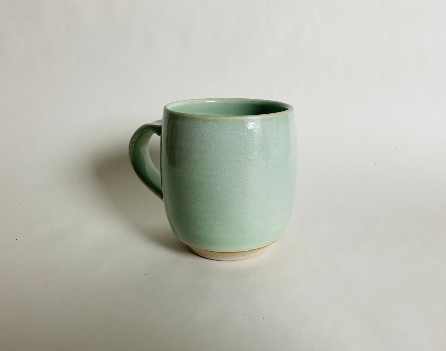 Medium Size Porcelaneous Mug with a Light Green Glaze