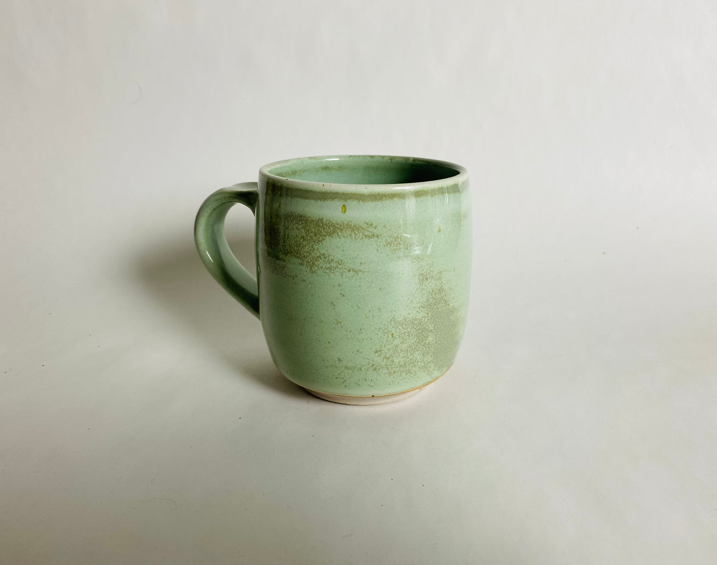 Medium Size Porcelaneous Mug with a Light Green Glaze