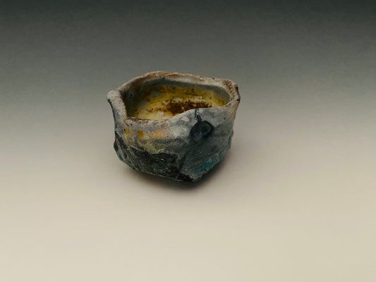 Wood fired sake cup, porcelain clay, glass inclusions.