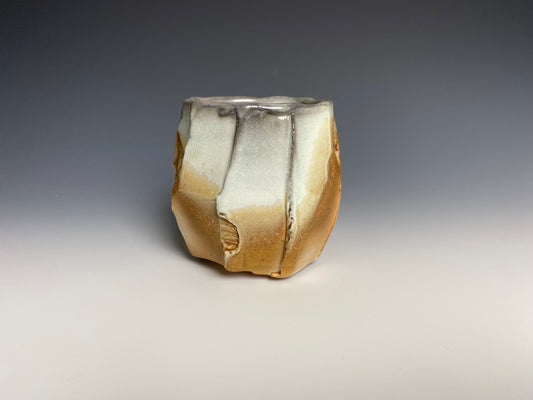 Wood fired faceted yunomi, porcelain clay.