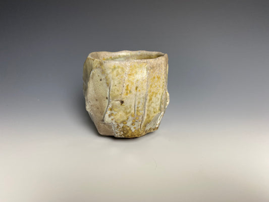 Wood fired porcelain faceted cup, Shino glaze.