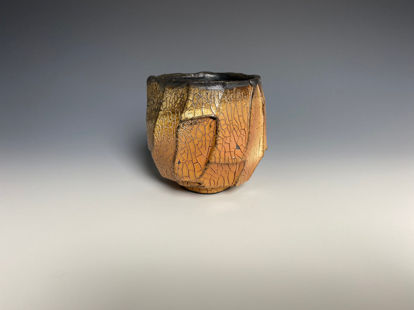 Wood fired faceted yunomi with crackle slip, black clay. (Copy)