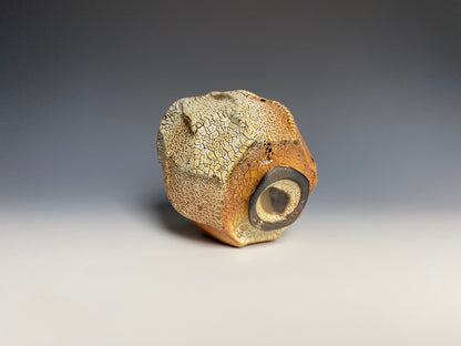 Wood fired faceted yunomi with crackle slip, black clay.