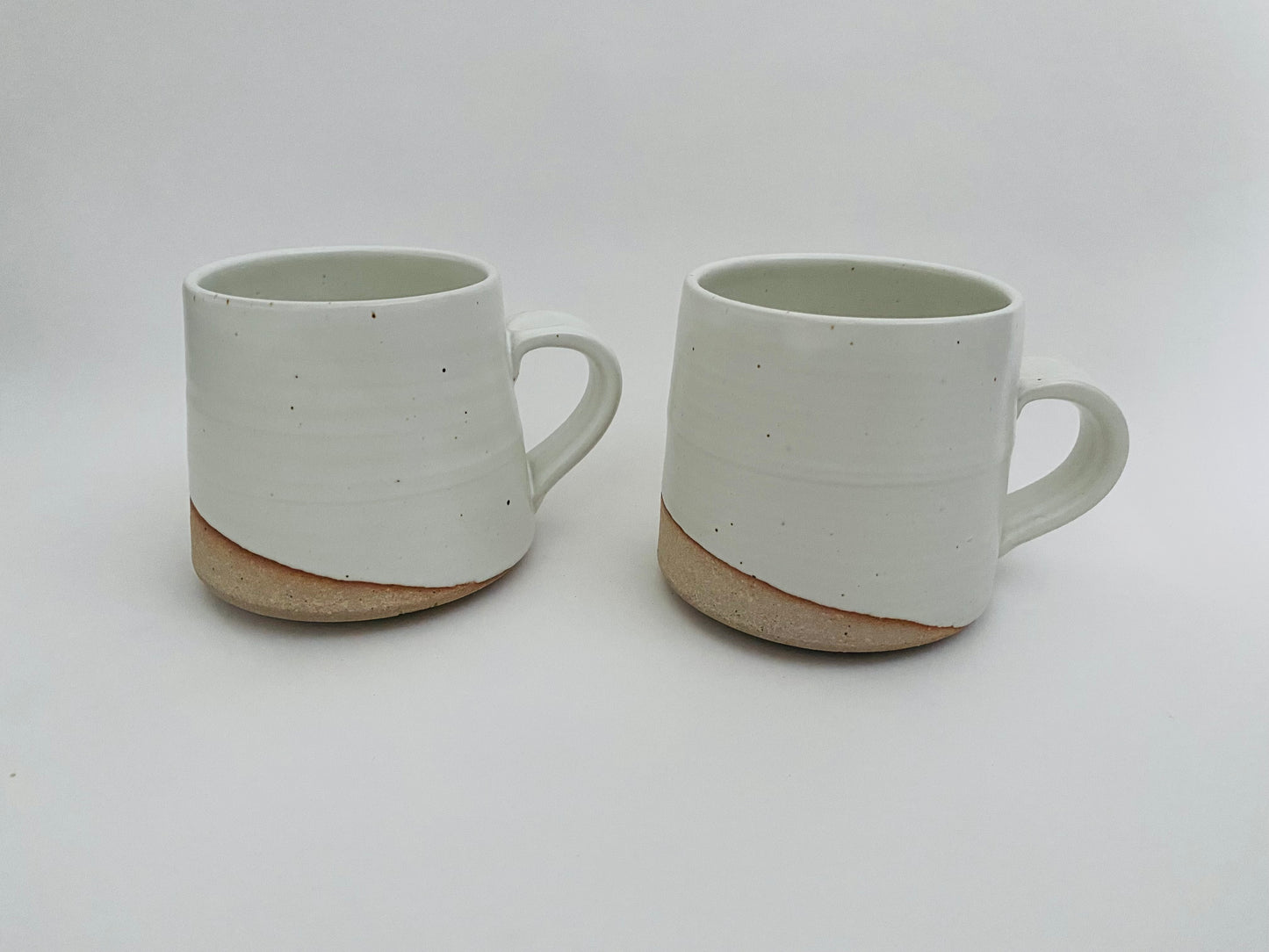 A pair of white mugs