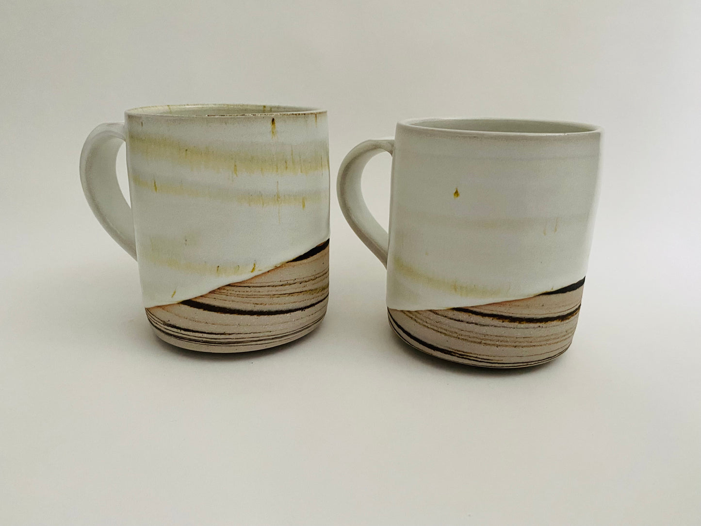A pair of large mugs with marbleized clay