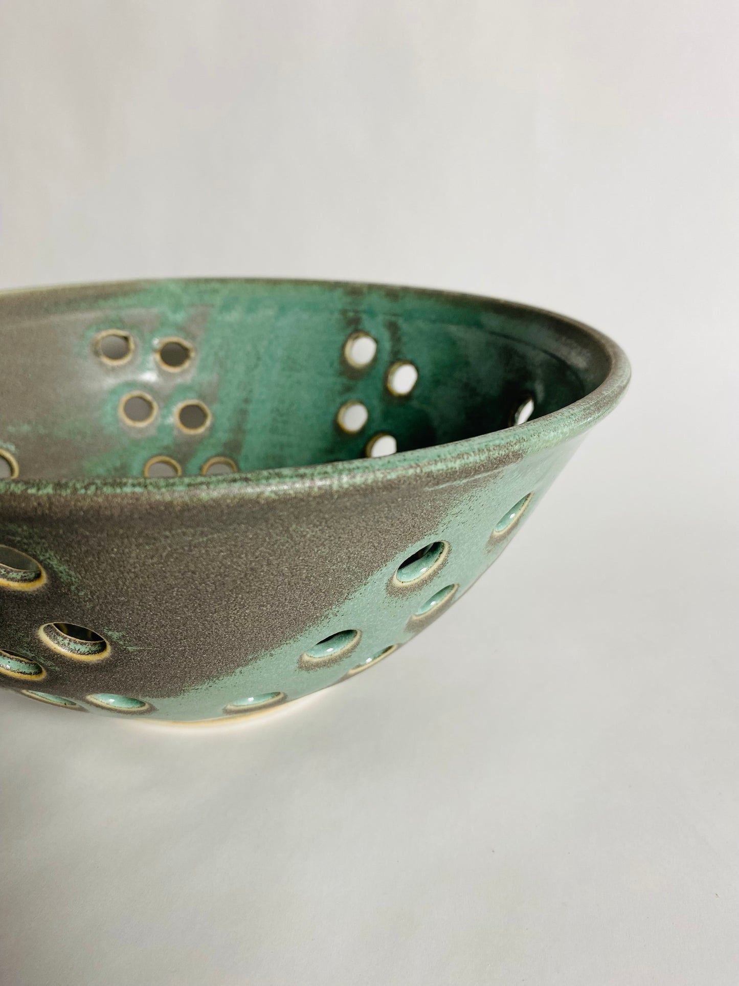 Fruit Bowl with Holes in a Green/Carbon Glaze