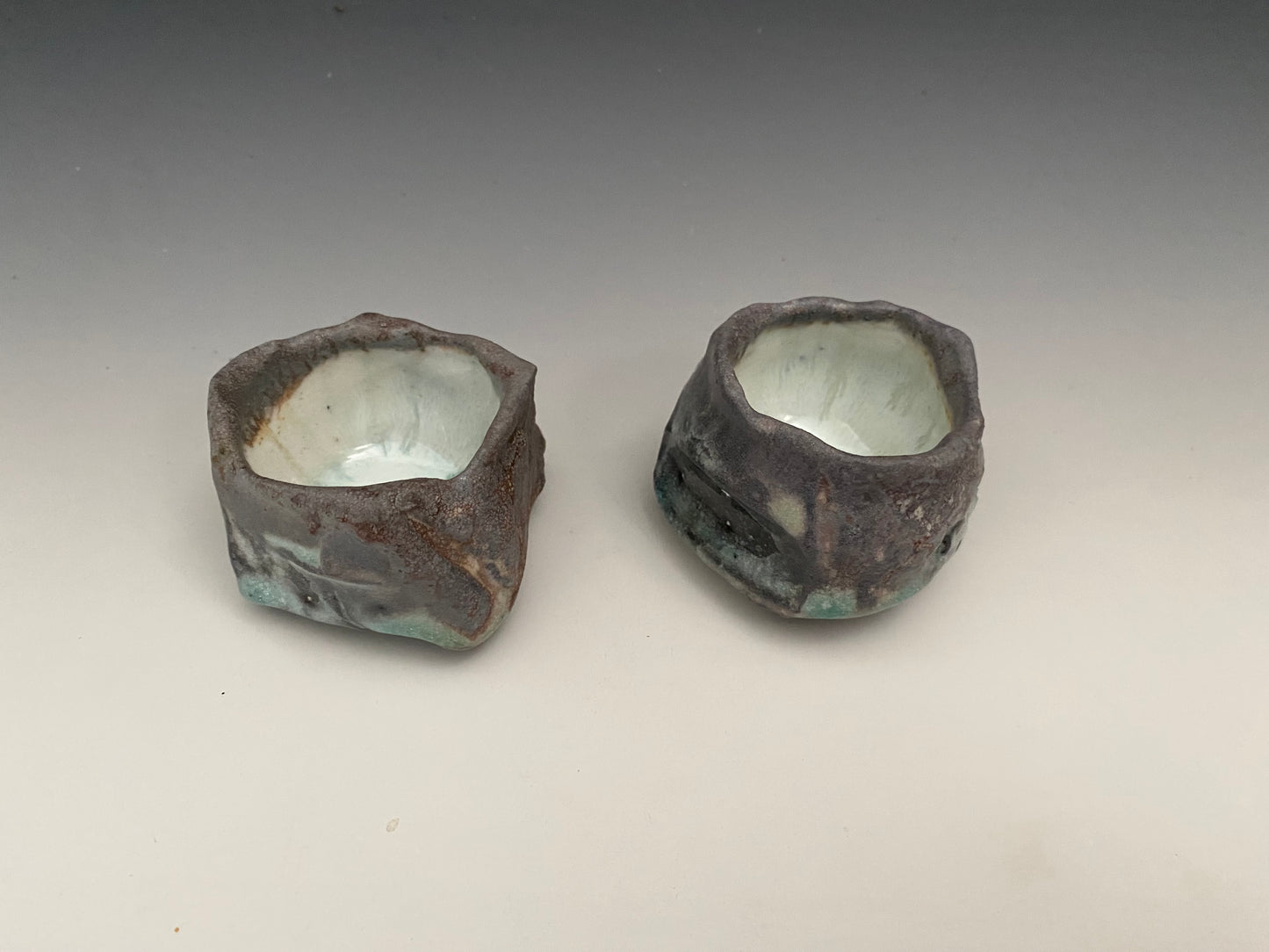 a pair of wood fired sake cups