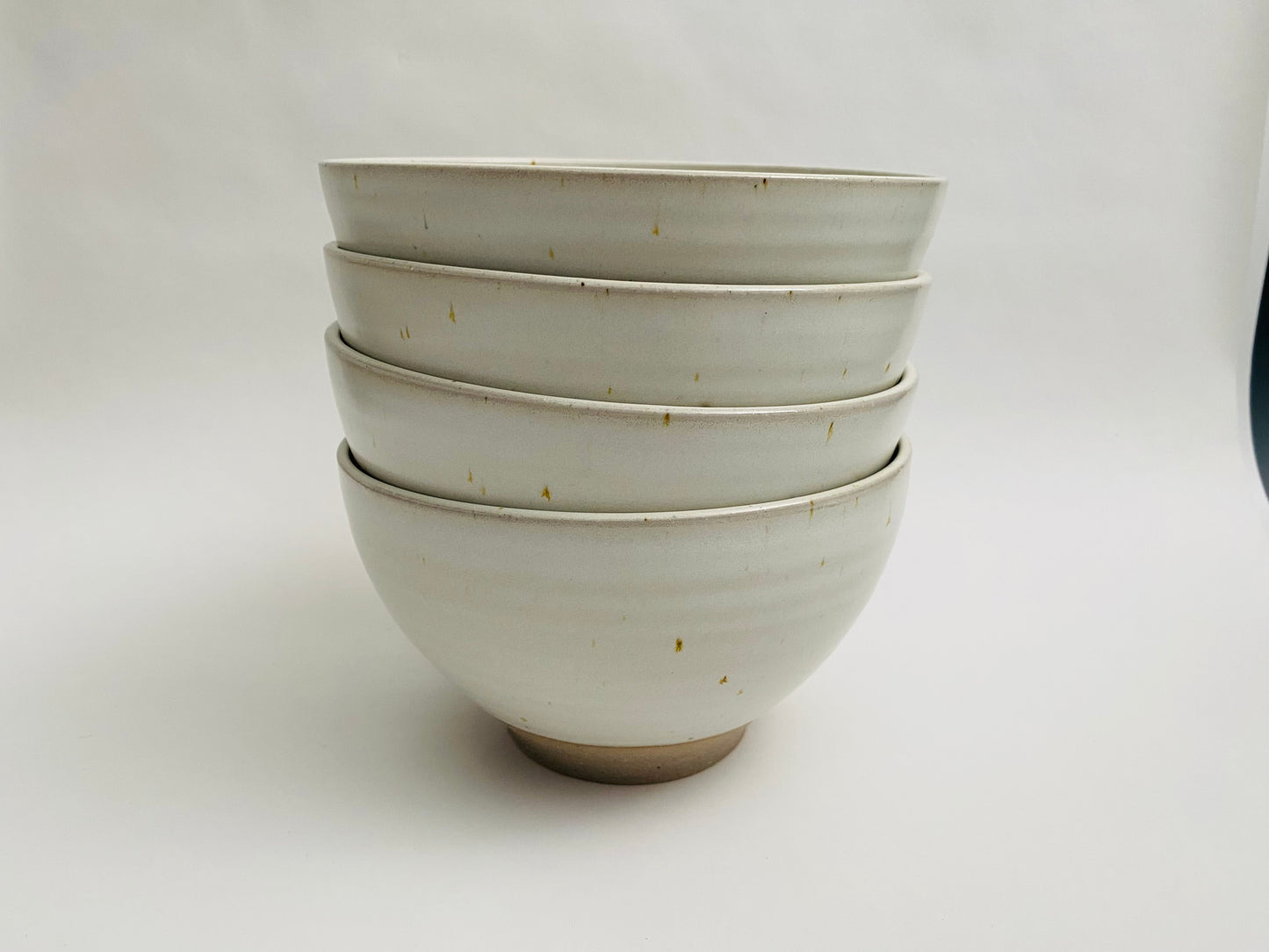 A set of 4 ramen bowls in a white glaze with speckles